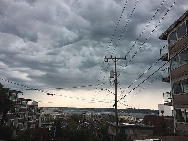 Storm clouds gather on Seattle street horizon.