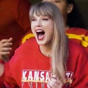 Singer-songwriter Taylor Swift wearing Kansas City Chiefs red tee shirt, rooting for Travis Kelce, the football team's tight end and her boyfriend.